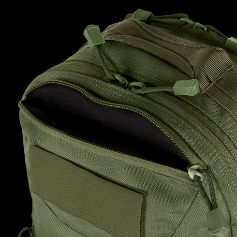Close-up of the Condor Venture Backpack 27.5L in olive green, featuring a partially unzipped front pocket that reveals the interior lining.